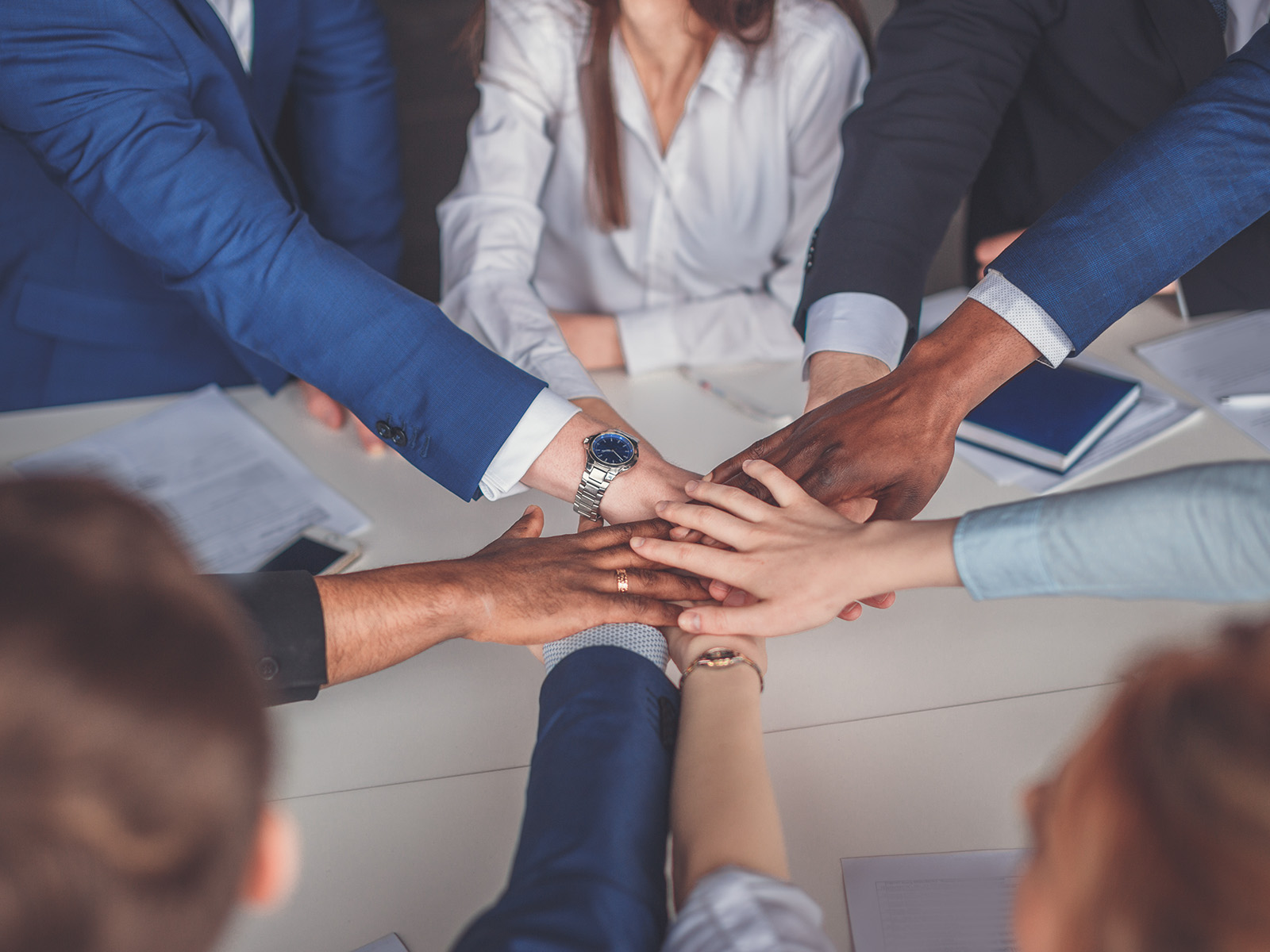 Team hands joined sustainability commitment